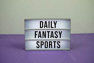 Daily Fantasy Sports text on LED lightbox on purple background