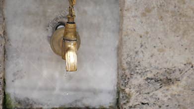 A beautifully designed vintage water faucet featuring an appealing dripping water effect