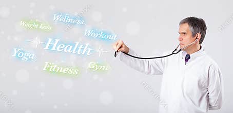 Clinical doctor pointing to health and fitness collection of words