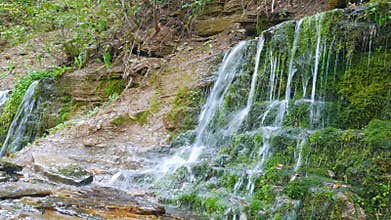 Refreshing waterfalls cascade. Russia, Izborsk, Slavonic springs.