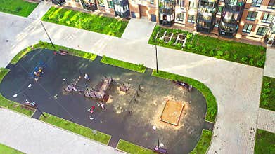 Areal footage of the children playing on the playground in the modern district, City