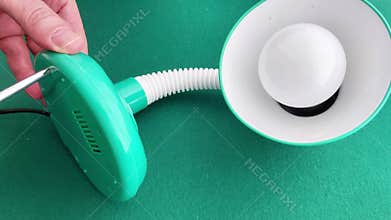 Uses Screwdriver to Assemble or Repair Green Desk Lamp with Flexible Neck