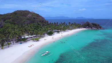 bangka boat at Malcapuya Island beach, turquoise sea. Amazing aerial view drone