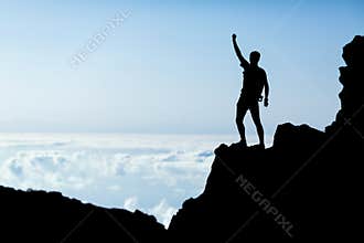 Hiking success silhouette, man trail runner in mountains