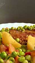 Pork chop with peas and potatoes.