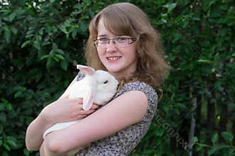 Girl with rabbit on hands