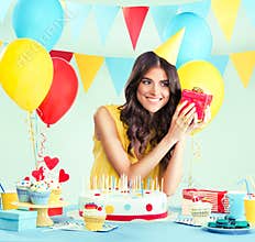 Beautiful woman holding a present at her birthday