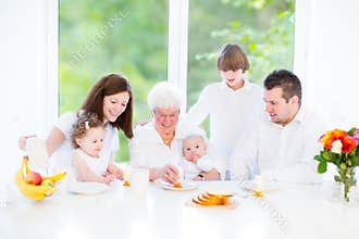 Happy young family enjoying Easter breakfast