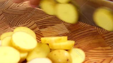 Slicing potatoes into bite-sized pieces
