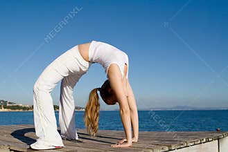 Fit healthy woman doing back bend