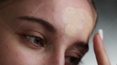 Young Girl Practices Makeup In Bright Room