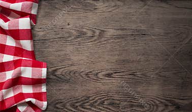 Picnic tablecloth on old wooden table top view