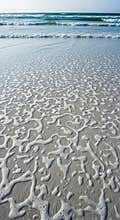 Calm Sea Washing Over Sandy Beach