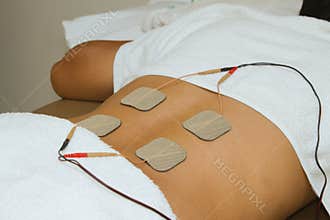 Patient applying electrical stimulation therapy ( TENS )