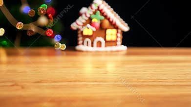 Gingerbread House and Christmas Lights Sitting on a Wooden Table