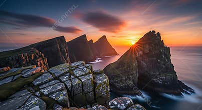 Jagged sea stacks and rocky cliffs at sunset with ocean waves image