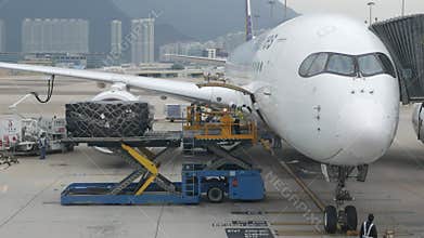 View at airside in HKG Hongkong Airport while ground service staffs loaders doing ground service operation of Philippines airline