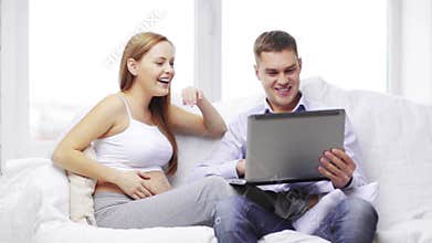 Happy family looking with laptop computer