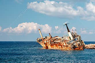 The Edro III, Pegeia, Cyprus - rusting shipwreck on calm sea under blue sky with clouds