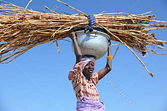 Woman carrying straw