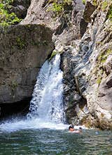 Swimmer taking selfie in water, Iadolina waterfall
