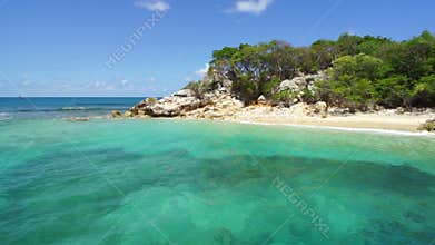 Ocean waves crashing in a rocky coast of Labadee, Haiti. Idyllic beach, exotic wild tropical beach with white sand and clear turqu