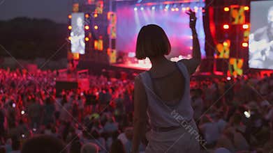 Woman is dancing at open air music festival