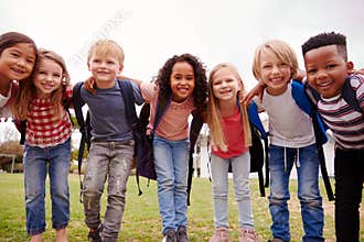 Portrait Of Excited Elementary School Pupils On Playing Field At Break Time