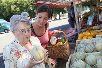 Elderly woman with homecarer at the market