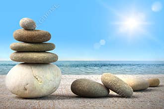 Stack of spa rocks on wood against blue sky