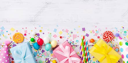 Birthday party banner or background with gift or present boxes, holiday supplies and confetti. Top view