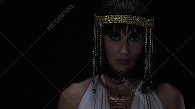 Close up footage of the look of Cleopatra, wearing white dress and jewelry