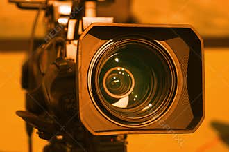 Video camera on the crane conducts shooting of a wedding in the hall of celebrations against the background.