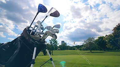 Many golf clubs in one bag on a field.