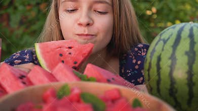 Young girl eat a delicious watermelon slice - close up