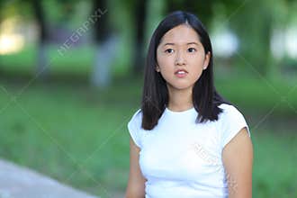 Young girl in the park learning with tablet