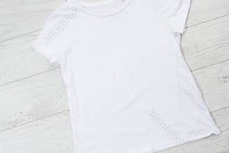 T-shirt mockup, t shirt top view. empty tshirt for logo on wooden floor copy space mock up. Casual clothes background