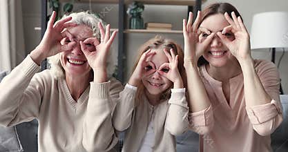 Happy funny multigenerational women family have fun make binoculars