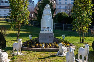 Statue of Bernadette of Lourdes with flowers