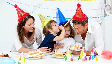 Happy family having fn while eating birthday cake