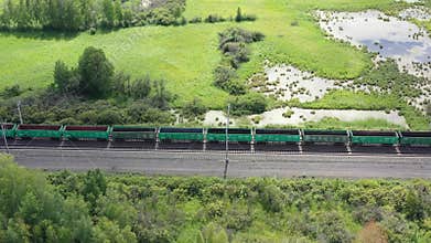 Aerial view of railway and freight train in rural landscape