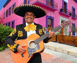 Charro Mariachi playing guitar Mexico houses