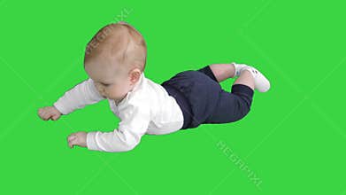 Baby lays on his stomach and holds his head on a Green Screen, Chroma Key.