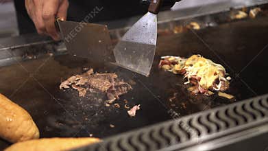 Cooking Philly`s cheese steak sandwich at festival stall