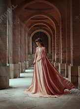 Sad princess in a vintage royal dress and in a cloak that flies in the wind.