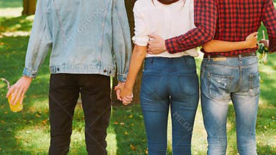 Polyamorous relationship woman standing two guys