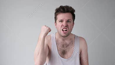 Alcoholic man showing his fist and shouting with angry expression