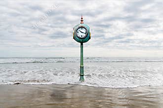 A clock in rising sea waters depicting the metaphors of time and change