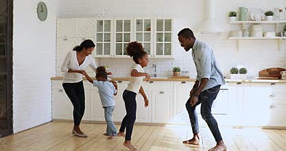 Happy young parents having fun with overjoyed small kids.