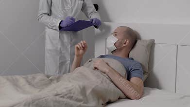 A sick man lies in bed with a high temperature. Coronavirus from China affects the lungs. Nearby is a doctor in